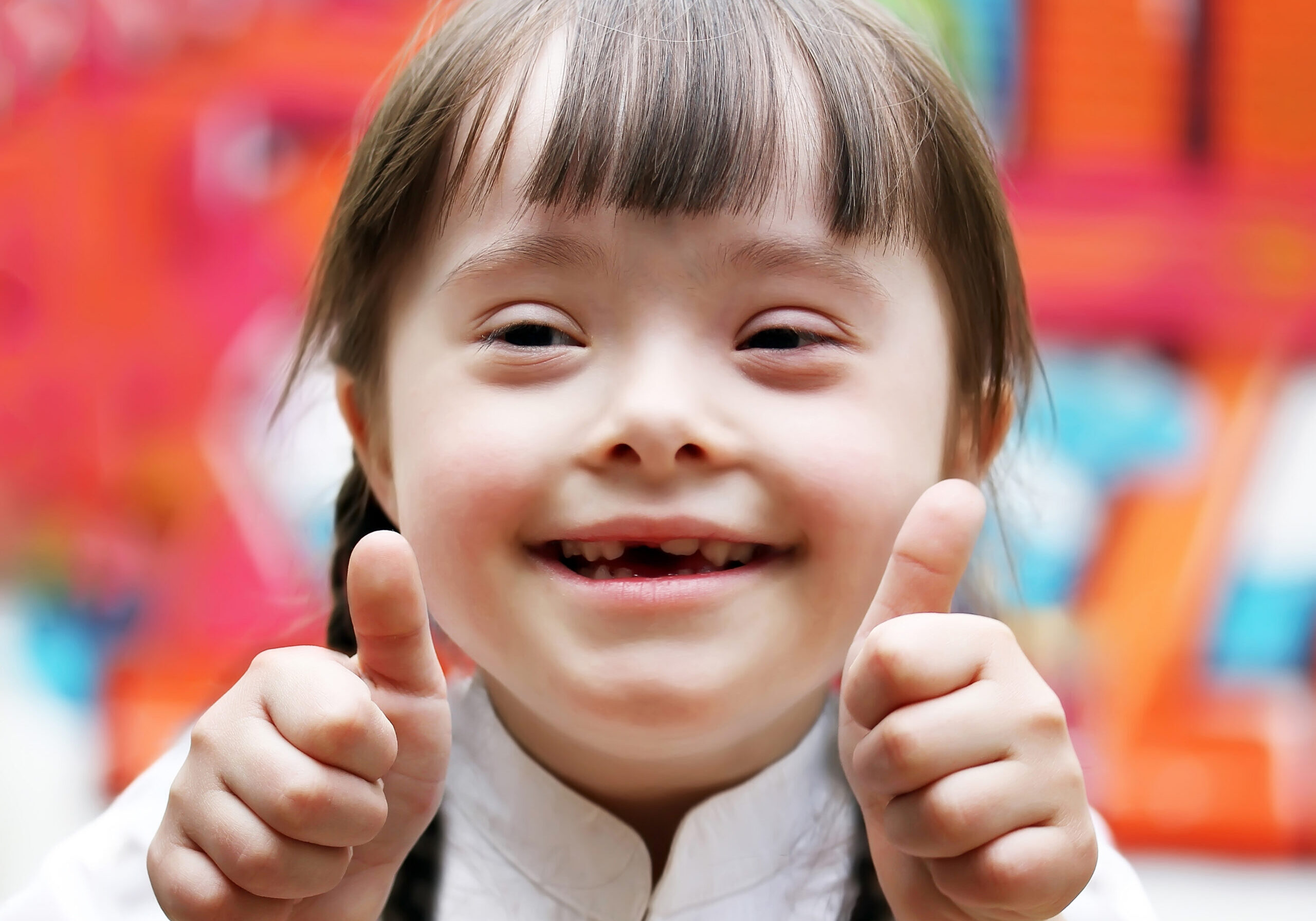 Portrait of beautiful happy girl giving thumbs up.